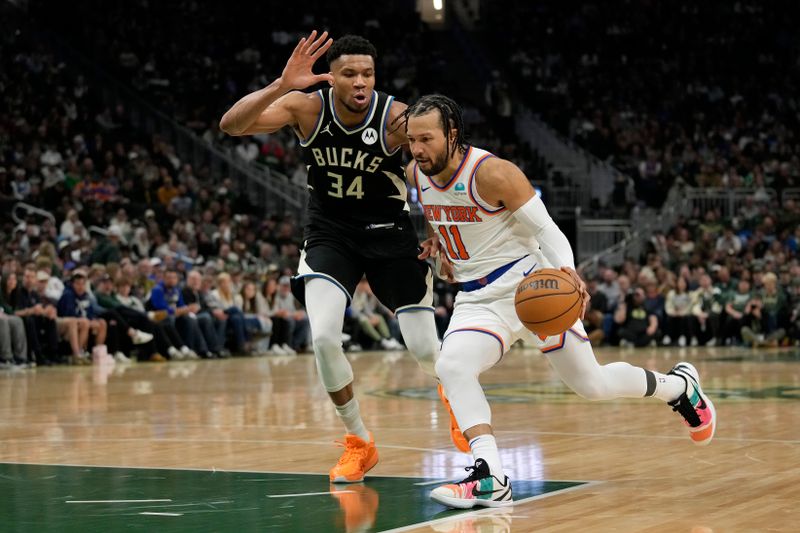 MILWAUKEE, WISCONSIN - APRIL 07: Jalen Brunson #11 of the New York Knicks dribbles the ball against Giannis Antetokounmpo #34 of the Milwaukee Bucks during the second half at Fiserv Forum on April 07, 2024 in Milwaukee, Wisconsin. NOTE TO USER: User expressly acknowledges and agrees that, by downloading and or using this photograph, User is consenting to the terms and conditions of the Getty Images License Agreement. (Photo by Patrick McDermott/Getty Images)