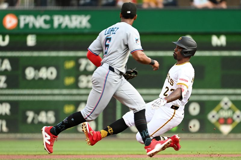 Jun 10, 2025; Pittsburgh, Pennsylvania, USA; Pittsburgh Pirates Andrew McCutchen (22) slides past Miami Marlins second baseman Otto Lopez (6) for a double in the first inning at PNC Park. Mandatory Credit: Philip G. Pavely-Imagn Images
