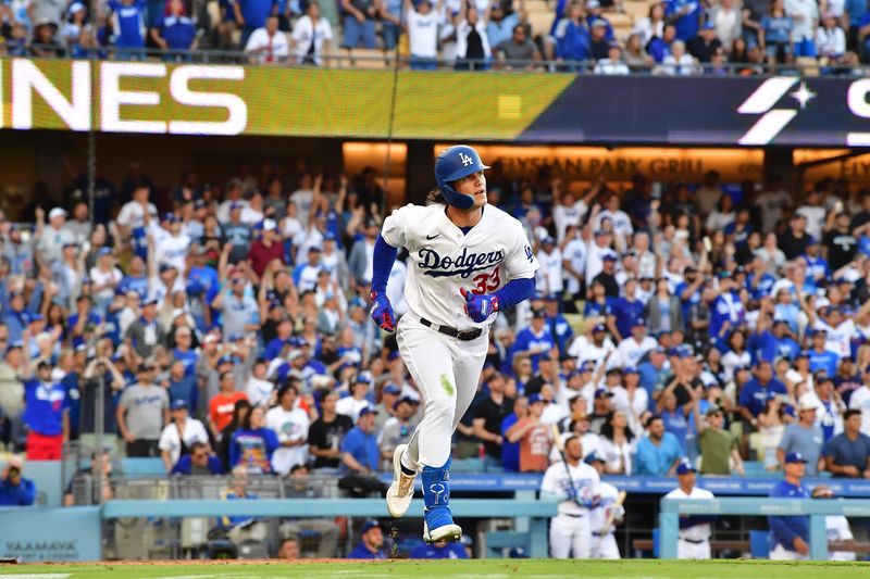 Jun 24, 2023; Los Angeles, California, USA; Los Angeles Dodgers center fielder James Outman (33) hits a ground rule RBI double against the Houston Astros during the eighth inning at Dodger Stadium. Mandatory Credit: Gary A. Vasquez-USA TODAY Sports