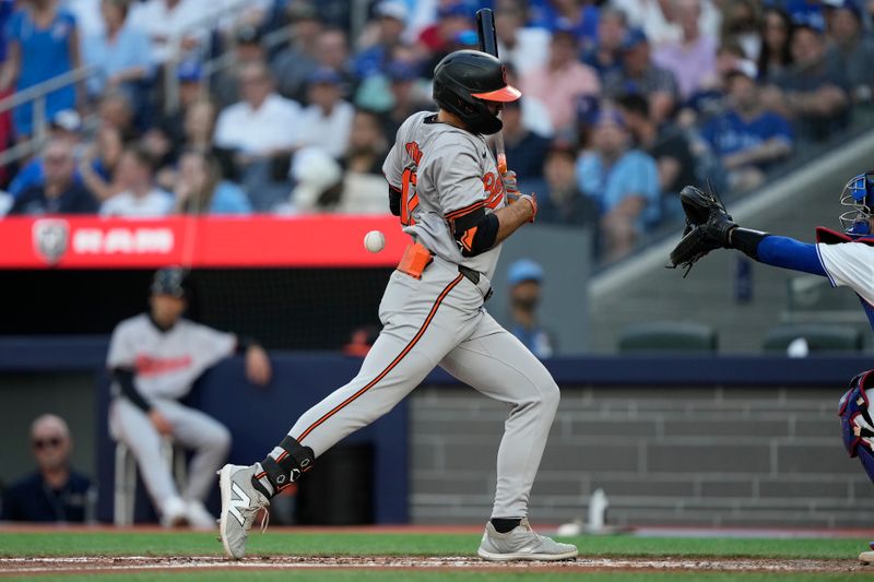 Jun 4, 2024; Toronto, Ontario, CAN;  Baltimore Orioles center fielder Colton Cowser (17) is hit in the back by a pitch from Toronto Blue Jays pitcher Genesis Cabrera (not pictured) during the third inning at Rogers Centre. Mandatory Credit: John E. Sokolowski-USA TODAY Sports