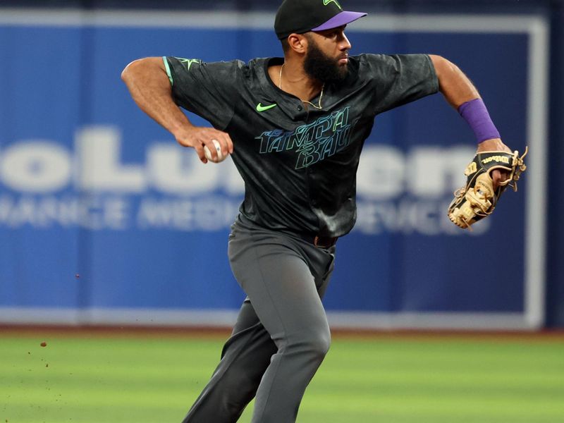 May 8, 2024; St. Petersburg, Florida, USA; Tampa Bay Rays outfielder Amed Rosario (10) throws the ball to first for a double play against the Chicago White Sox during the second inning at Tropicana Field. Mandatory Credit: Kim Klement Neitzel-USA TODAY Sports