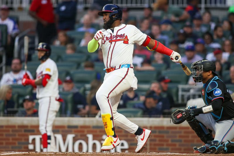 Apr 24, 2024; Atlanta, Georgia, USA; Atlanta Braves designated hitter Marcell Ozuna (20) hits a RBI single against the Miami Marlins in the third inning at Truist Park. Mandatory Credit: Brett Davis-USA TODAY Sports
