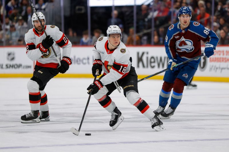 Jan 8, 2026; Denver, Colorado, USA; Ottawa Senators center Tim Stutzle (18) controls the puck ahead of right wing Michael Amadio (22) and Colorado Avalanche center Martin Necas (88) in the first period at Ball Arena. Mandatory Credit: Isaiah J. Downing-Imagn Images