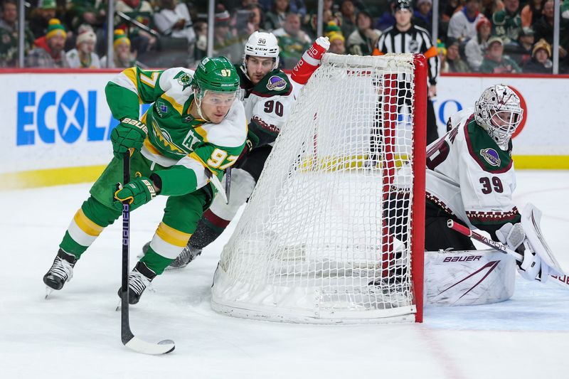 Jan 13, 2024; Saint Paul, Minnesota, USA; Minnesota Wild left wing Kirill Kaprizov (97) skates with the puck as Arizona Coyotes defenseman J.J. Moser (90) defends during the second period at Xcel Energy Center. Mandatory Credit: Matt Krohn-USA TODAY Sports