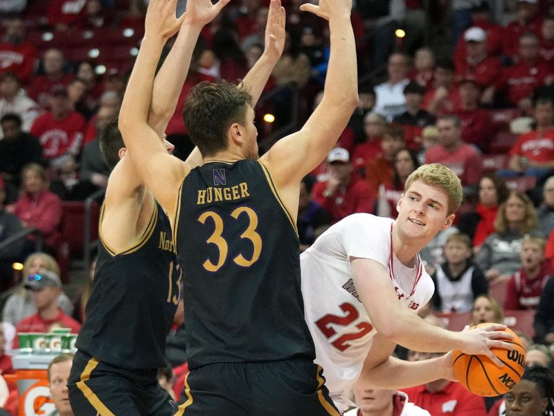 Jan 13, 2024; Madison, Wisconsin, USA; Wisconsin Badgers forward Steven Crowl (22) looks to pass against Northwestern Wildcats forward Luke Hunger (33) and guard Brooks Barnhizer (13) during the second half at the Kohl Center. Mandatory Credit: Kayla Wolf-USA TODAY Sports