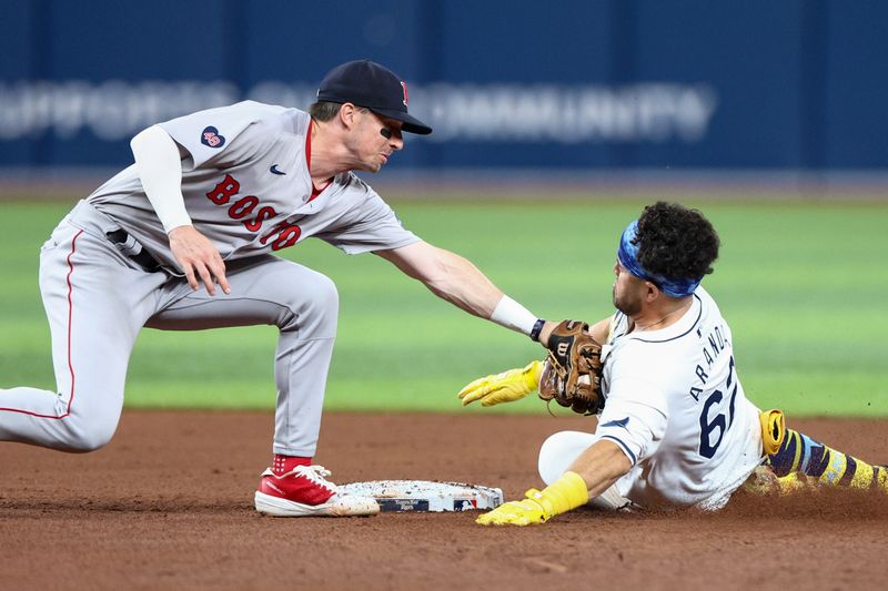 Sep 19, 2024; St. Petersburg, Florida, USA; Tampa Bay Rays first baseman Jonathan Aranda (62) is tagged out by Boston Red Sox second baseman Nick Sogard (75) in the sixth inning at Tropicana Field. Mandatory Credit: Nathan Ray Seebeck-Imagn Images