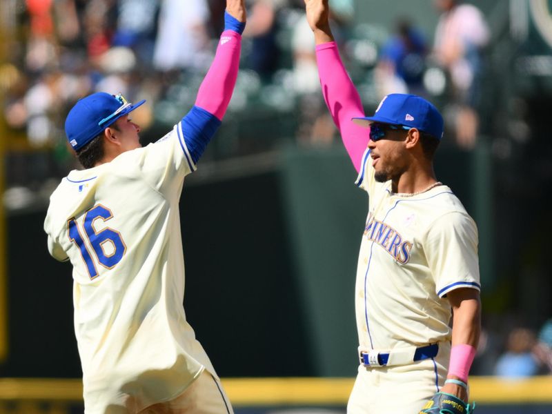 May 12, 2024; Seattle, Washington, USA; Seattle Mariners third baseman Luis Urias (16) and center fielder Julio Rodriguez (44) celebrate defeating the Oakland Athletics at T-Mobile Park. Mandatory Credit: Steven Bisig-USA TODAY Sports