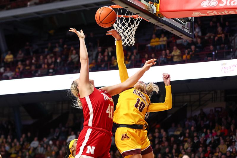 Jan 14, 2024; Minneapolis, Minnesota, USA; Minnesota Golden Gophers guard Mara Braun (10) blocks a shot by Nebraska Cornhuskers center Alexis Markowski (40) during the second half at Williams Arena. Mandatory Credit: Matt Krohn-USA TODAY Sports