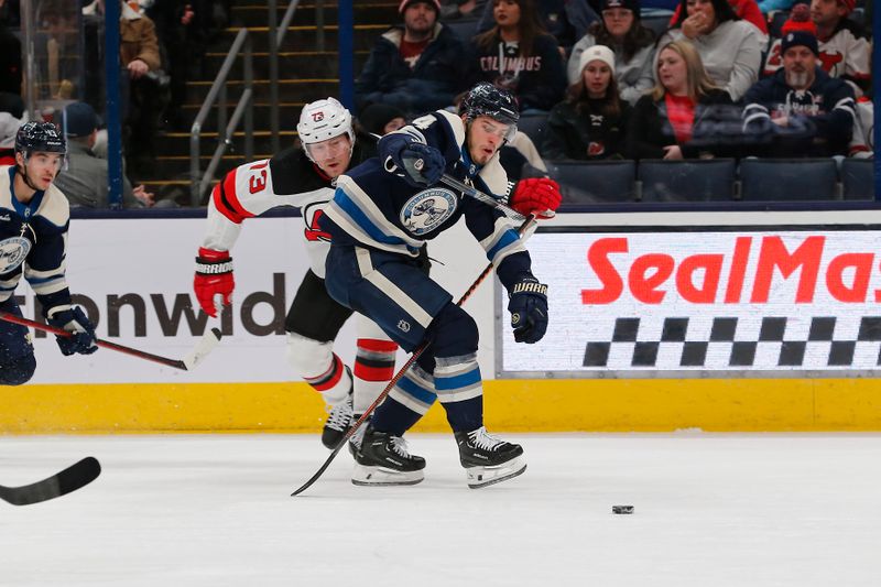 Jan 19, 2024; Columbus, Ohio, USA; New Jersey Devils right wing Tyler Toffoli (73) checks Columbus Blue Jackets Forward Cole Sillinger (4) during the first period at Nationwide Arena. Mandatory Credit: Russell LaBounty-USA TODAY Sports