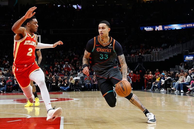 ATLANTA, GA - JANUARY 13: Kyle Kuzma #33 of the Washington Wizards drives to the basket during the game against the Atlanta Hawks on January 13, 2024 at State Farm Arena in Atlanta, Georgia.  NOTE TO USER: User expressly acknowledges and agrees that, by downloading and/or using this Photograph, user is consenting to the terms and conditions of the Getty Images License Agreement. Mandatory Copyright Notice: Copyright 2024 NBAE (Photo by Mercedes Oliver/NBAE via Getty Images)