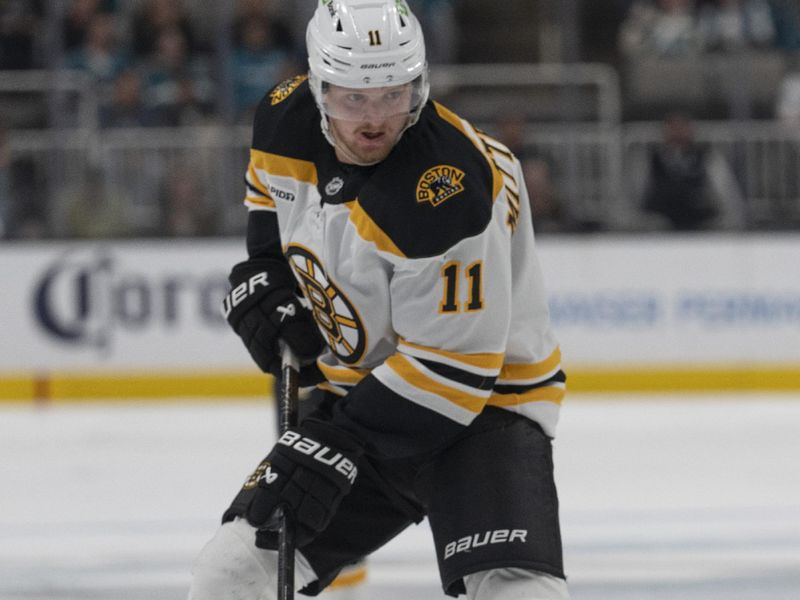 Mar 22, 2025; San Jose, California, USA;  Boston Bruins center Casey Mittelstadt (11) controls the puck during the third period against the San Jose Sharks at SAP Center at San Jose. Mandatory Credit: Stan Szeto-Imagn Images