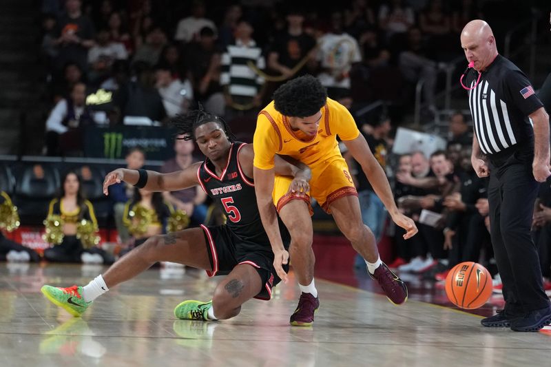 Jan 31, 2026; Los Angeles, California, USA; Southern California Trojans forward Jacob Cofie (6) and Rutgers Scarlet Knights guard Darren Buchanan Jr. (5) battle for the ball as referee Tim Comer watches in the second half at Galen Center. Mandatory Credit: Kirby Lee-Imagn Images