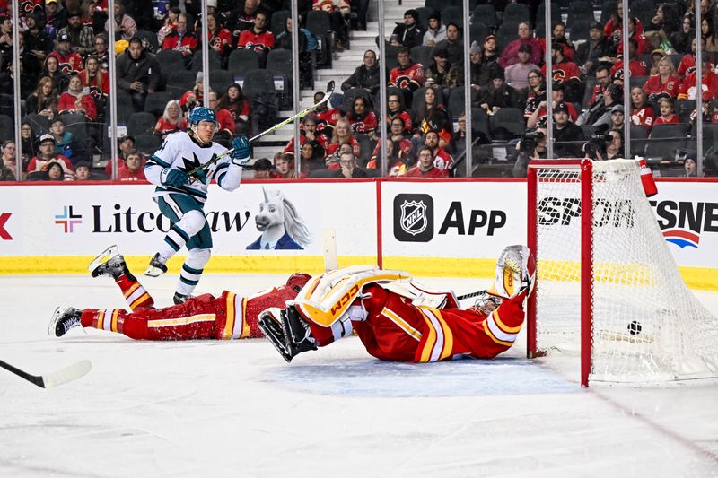 Feb 15, 2024; Calgary, Alberta, CAN; San Jose Sharks center Mikael Granlund (64) scores a goal against Calgary Flames goaltender Dustin Wolf (32) during the second period at Scotiabank Saddledome. Mandatory Credit: Brett Holmes-USA TODAY Sports