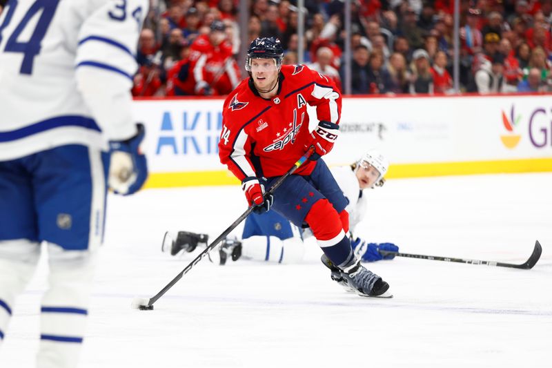 Mar 20, 2024; Washington, District of Columbia, USA; Washington Capitals defenseman John Carlson (74) skates with the puck as Toronto Maple Leafs left wing Tyler Bertuzzi (59) during the third period at Capital One Arena. Mandatory Credit: Amber Searls-USA TODAY Sports