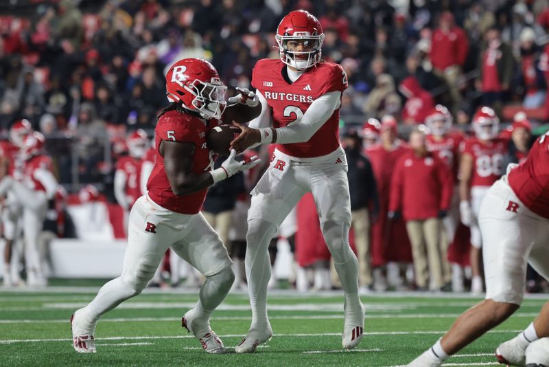 Nov 25, 2023; Piscataway, New Jersey, USA; Rutgers Scarlet Knights quarterback Gavin Wimsatt (2) hands off to running back Kyle Monangai (5) during the second half against the Maryland Terrapins at SHI Stadium. Mandatory Credit: Vincent Carchietta-USA TODAY Sports