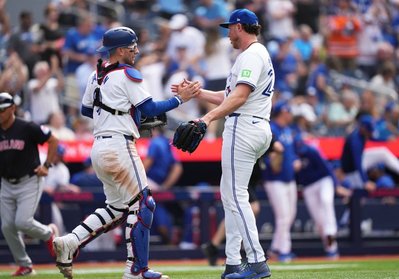 Jun 15, 2024; Toronto, Ontario, CAN; Toronto Blue Jays catcher Danny Jansen (9) celebrates the win with relief pitcher Nate Pearson (24) at the end of the ninth inning after a game against the Cleveland Guardians at Rogers Centre. Mandatory Credit: Nick Turchiaro-USA TODAY Sports