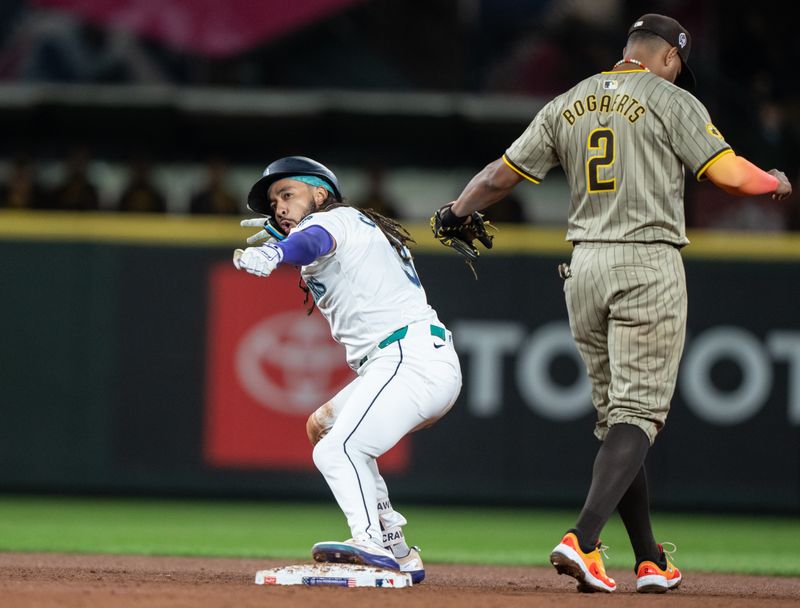 Sep 11, 2024; Seattle, Washington, USA;  Seattle Mariners shortstop J.P. Crawford (3) celebrates at second base after hitting a two-run double during the sixth inning against the San Diego Padres at T-Mobile Park. At right is San Diego Padres shortstop Justin Turner (2)Mandatory Credit: Stephen Brashear-Imagn Images