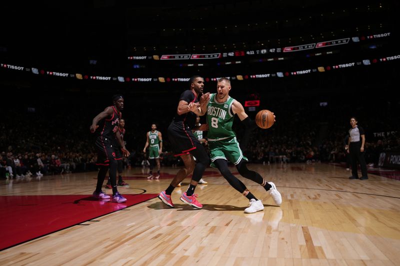 TORONTO, CANADA - JANUARY 15:  Kristaps Porzingis #8 of the Boston Celtics handles the ball during the game against the Toronto Raptors on January 15, 2024 at the Scotiabank Arena in Toronto, Ontario, Canada.  NOTE TO USER: User expressly acknowledges and agrees that, by downloading and or using this Photograph, user is consenting to the terms and conditions of the Getty Images License Agreement.  Mandatory Copyright Notice: Copyright 2024 NBAE (Photo by Mark Blinch/NBAE via Getty Images)