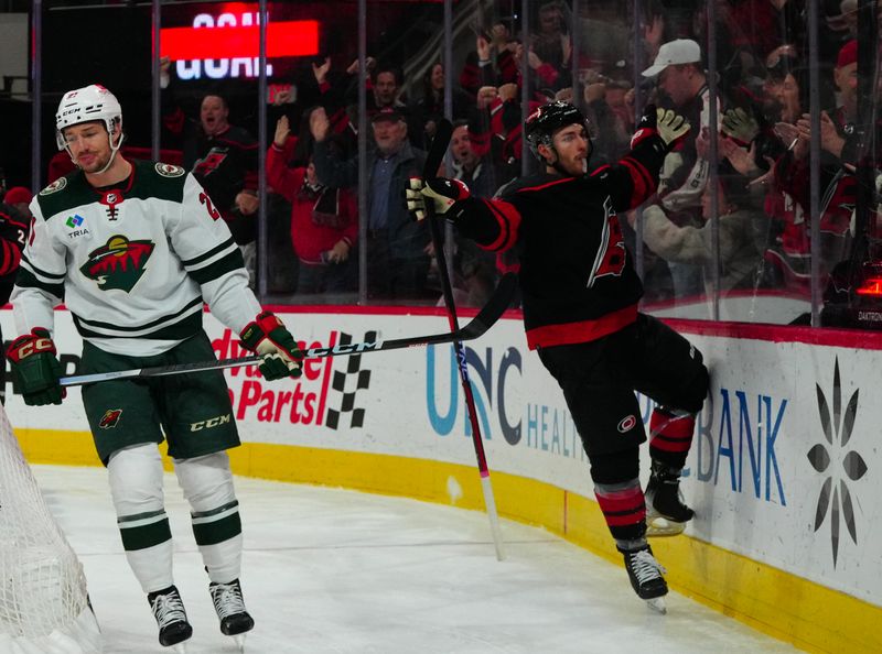 Jan 21, 2024; Raleigh, North Carolina, USA;  Carolina Hurricanes left wing Michael Bunting (58) celebrates his goal against the Minnesota Wild during the third period at PNC Arena. Mandatory Credit: James Guillory-USA TODAY Sports