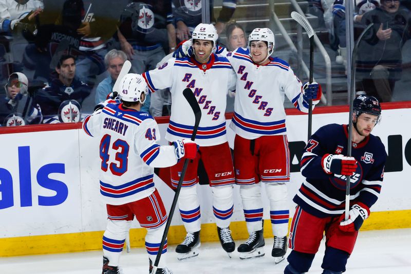 Mar 12, 2026; Winnipeg, Manitoba, CAN; New York Rangers forward Tye Kartye (24) is congratulated by his teammates on his goal against the Winnipeg Jets during the third period at Canada Life Centre. Mandatory Credit: Terrence Lee-Imagn Images