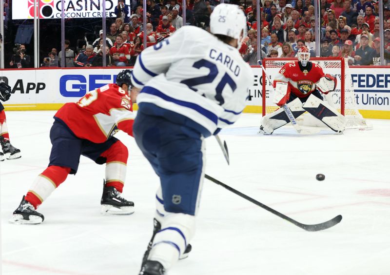 May 11, 2025; Sunrise, Florida, USA; Toronto Maple Leafs defenseman Brandon Carlo (25) shoots as Florida Panthers goaltender Sergei Bobrovsky (72) looks at the puck during the third period in game four of the second round of the 2025 Stanley Cup Playoffs at Amerant Bank Arena. Mandatory Credit: Kim Klement Neitzel-Imagn Images