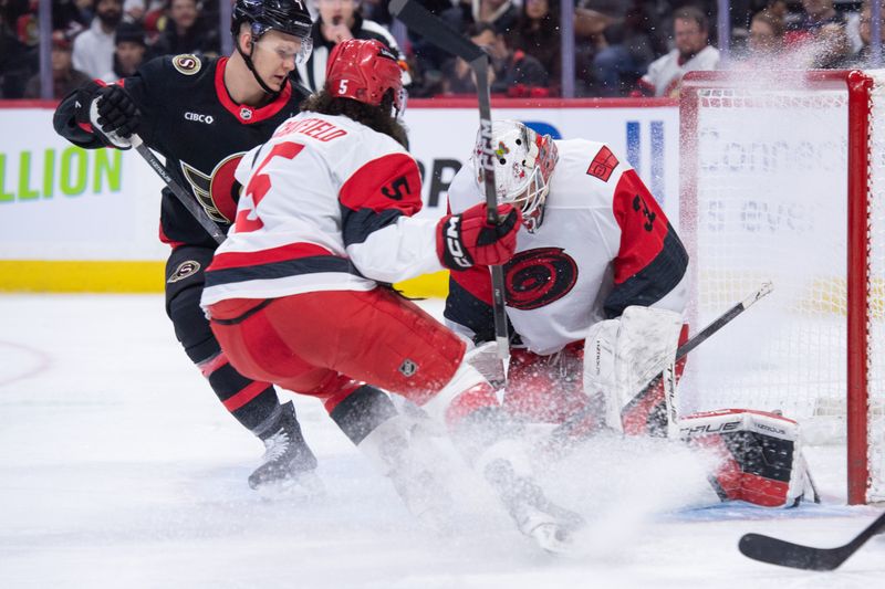 Jan 24, 2026; Ottawa, Ontario, CAN; Carolina Hurricanes goalie Brandon Bussi (32) makes a save in front of Ottawa Senators left wing Brady Tkachuk (7) in the first period at the Canadian Tire Centre. Mandatory Credit: Marc DesRosiers-IMAGN Images