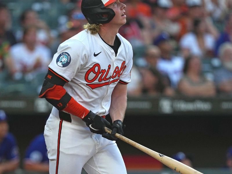 Jun 27, 2024; Baltimore, Maryland, USA; Baltimore Orioles outfielder Heston Kjerstad (13) hits a two-run home run in the third inning against the Texas Rangers at Oriole Park at Camden Yards. Mandatory Credit: Mitch Stringer-USA TODAY Sports