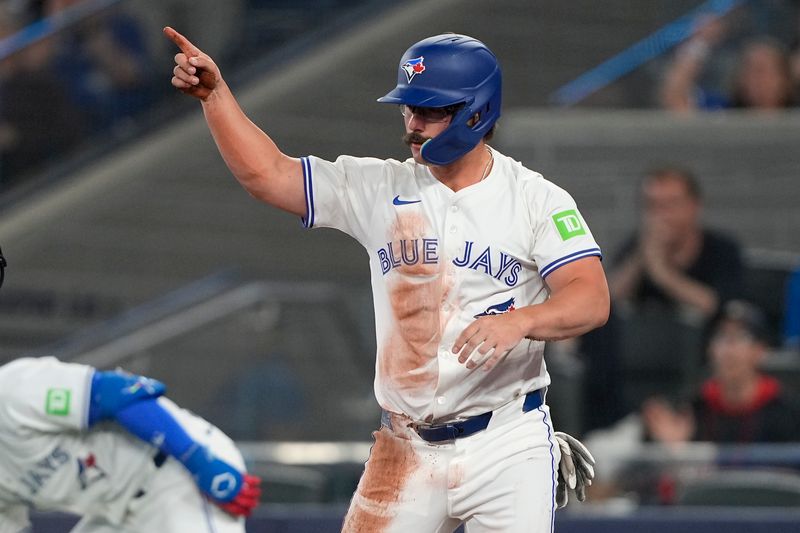 Jun 5, 2025; Toronto, Ontario, CAN; Toronto Blue Jays second baseman Davis Schneider (36) gestures to center fielder Myles Straw (not pictured) after scoring on his double during the second inning against the Philadelphia Phillies at Rogers Centre. Mandatory Credit: John E. Sokolowski-Imagn Images