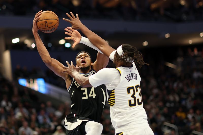 MILWAUKEE, WISCONSIN - NOVEMBER 22: Giannis Antetokounmpo #34 of the Milwaukee Bucks works against Myles Turner #33 of the Indiana Pacers during the second half of a game in the NBA Emirates Cup at Fiserv Forum on November 22, 2024 in Milwaukee, Wisconsin. NOTE TO USER: User expressly acknowledges and agrees that, by downloading and or using this photograph, User is consenting to the terms and conditions of the Getty Images License Agreement. (Photo by Stacy Revere/Getty Images)