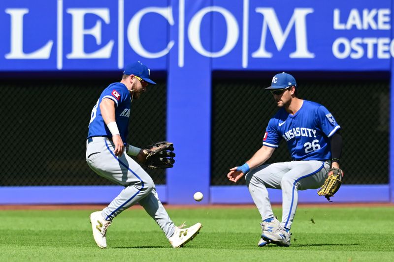 Aug 28, 2024; Cleveland, Ohio, USA; Kansas City Royals center fielder Kyle Isbel (28) and right fielder Adam Frazier (26) field an RBI single hit by Cleveland Guardians first baseman Josh Naylor (not pictured) during the seventh inning at Progressive Field. Mandatory Credit: Ken Blaze-USA TODAY Sports