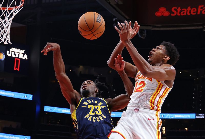 ATLANTA, GEORGIA - OCTOBER 08:  Aaron Nesmith #23 of the Indiana Pacers knocks the ball away from De'Andre Hunter #12 of the Atlanta Hawks during the first quarter at State Farm Arena on October 08, 2024 in Atlanta, Georgia.  NOTE TO USER: User expressly acknowledges and agrees that, by downloading and/or using this photograph, user is consenting to the terms and conditions of the Getty Images License Agreement.  (Photo by Kevin C. Cox/Getty Images)