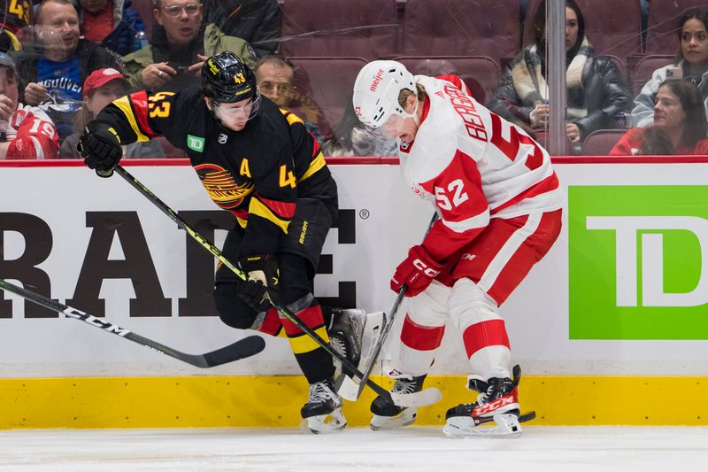 Feb 13, 2023; Vancouver, British Columbia, CAN; Vancouver Canucks defenseman Quinn Hughes (43) battles with Detroit Red Wings forward Jonatan Berggren (52) in the third period at Rogers Arena. Red Wings won 6-1. Mandatory Credit: Bob Frid-USA TODAY Sports