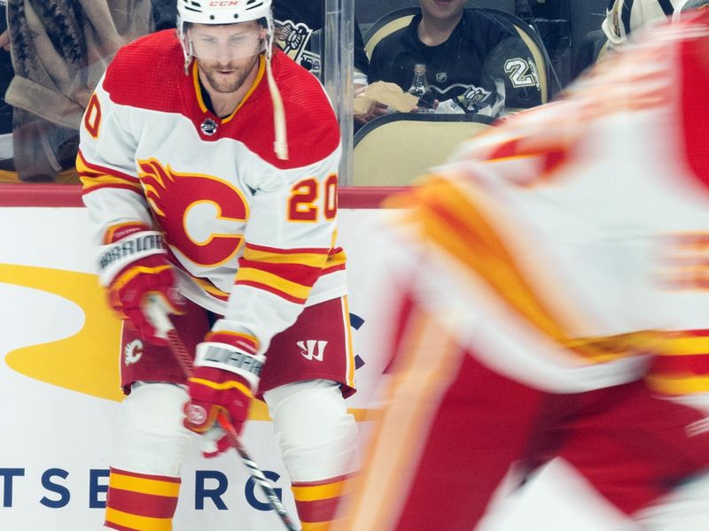 Oct 14, 2023; Pittsburgh, Pennsylvania, USA; Calgary Flames center Blake Coleman (20) stick handles the puck while his teammates skate around during warm up before the game against the Pittsburgh Penguins at PPG Paints Arena. Mandatory Credit: Scott Galvin-USA TODAY Sports