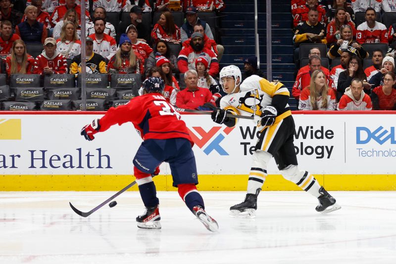 Nov 8, 2024; Washington, District of Columbia, USA; Pittsburgh Penguins defenseman Jack St. Ivany (3) shoots the puck as Washington Capitals defenseman Rasmus Sandin (38) defends in the second period at Capital One Arena. Mandatory Credit: Geoff Burke-Imagn Images