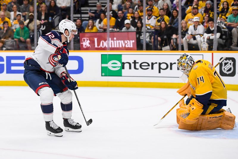 Apr 13, 2024; Nashville, Tennessee, USA; Columbus Blue Jackets center Alexandre Texier (42) shoots and scores against the Nashville Predators during the second period at Bridgestone Arena. Mandatory Credit: Steve Roberts-USA TODAY Sports