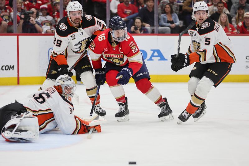 Jan 15, 2024; Sunrise, Florida, USA; Florida Panthers center Aleksander Barkov (16) passes the puck as Anaheim Ducks goaltender John Gibson (36), center Sam Carrick (39), and defenseman Urho Vaakanainen (5) defend during the second period at Amerant Bank Arena. Mandatory Credit: Sam Navarro-USA TODAY Sports