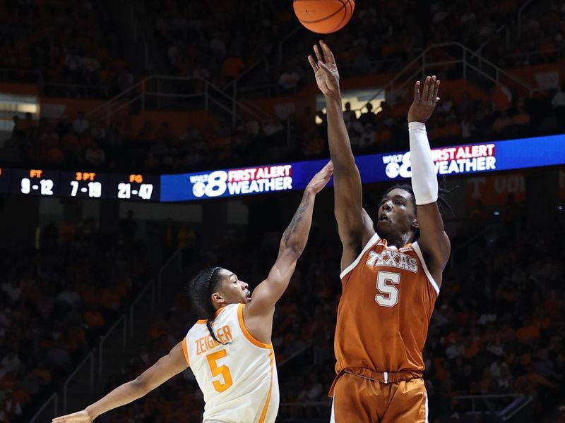 Jan 28, 2023; Knoxville, Tennessee, USA; Texas Longhorns guard Marcus Carr (5) shoots the ball against Tennessee Volunteers guard Zakai Zeigler (5) during the second half at Thompson-Boling Arena. Mandatory Credit: Randy Sartin-USA TODAY Sports