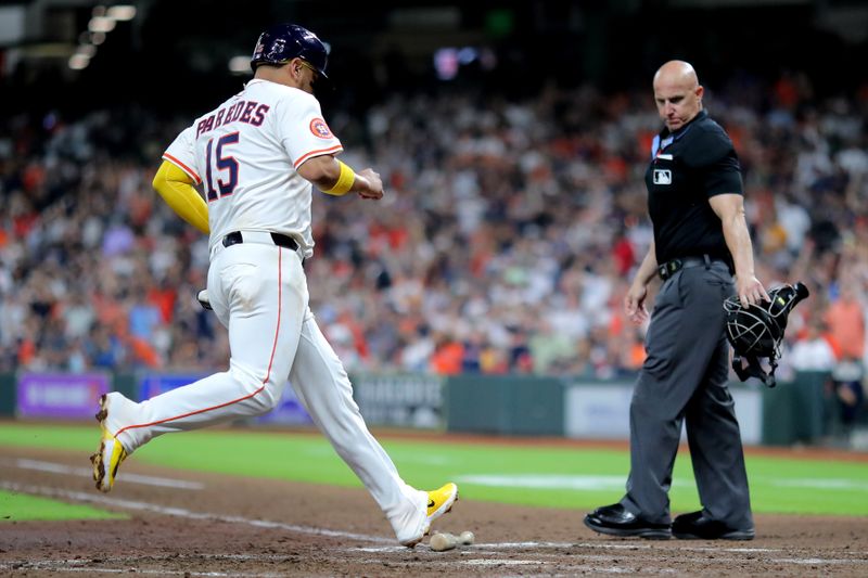 Jun 26, 2025; Houston, Texas, USA; Houston Astros third baseman Isaac Paredes (15) crosses home plate to score a run against the Philadelphia Phillies during the eighth inning at Daikin Park. Mandatory Credit: Erik Williams-Imagn Images