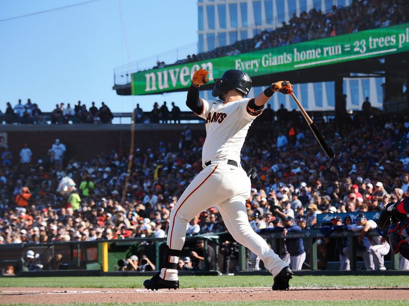 Aug 27, 2023; San Francisco, California, USA; San Francisco Giants first baseman J.D. Davis (7) hits an RBI single against the Atlanta Braves during the first inning at Oracle Park. Mandatory Credit: Kelley L Cox-USA TODAY Sports