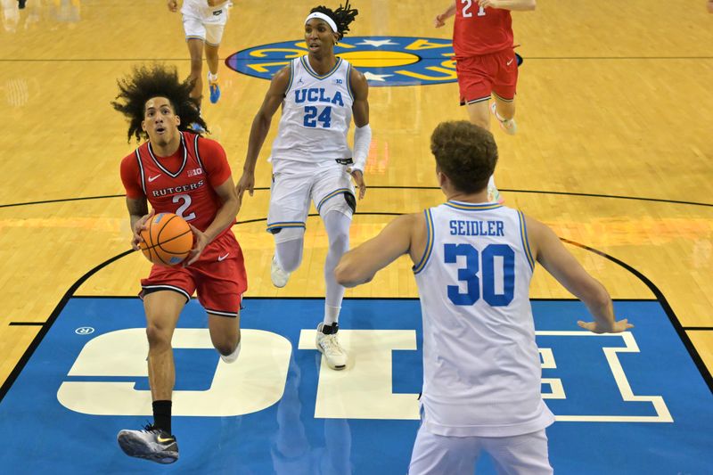 Feb 3, 2026; Los Angeles, California, USA;  Rutgers Scarlet Knights guard Lino Mark (2) gets past UCLA Bruins forward Steven Jamerson II (24) and guard Jack Seidler (30) for a basket in the second half at Pauley Pavilion presented by Wescom Financial. Mandatory Credit: Jayne Kamin-Oncea-Imagn Images