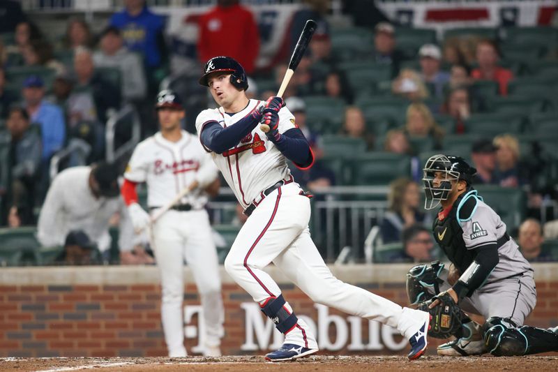 Apr 6, 2024; Atlanta, Georgia, USA; Atlanta Braves third baseman Austin Riley (27) hits a single against the Arizona Diamondbacks in the seventh inning at Truist Park. Mandatory Credit: Brett Davis-USA TODAY Sports