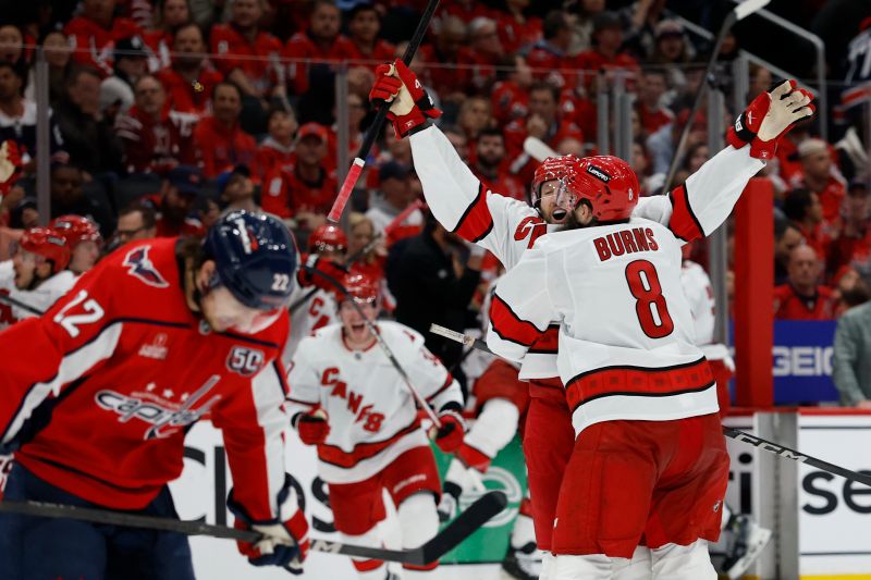May 6, 2025; Washington, District of Columbia, USA; Carolina Hurricanes defenseman Jaccob Slavin (74) celebrates with teammates after scoring the game winning goal in overtime against the Washington Capitals in game one of the second round of the 2025 Stanley Cup Playoffs at Capital One Arena. Mandatory Credit: Geoff Burke-Imagn Images