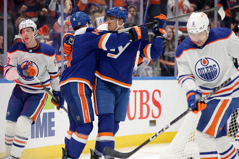 Dec 19, 2023; Elmont, New York, USA; New York Islanders left wing Anders Lee (27) celebrates his power play goal against the Edmonton Oilers with center Bo Horvat (14) during the second period at UBS Arena. Mandatory Credit: Brad Penner-USA TODAY Sports