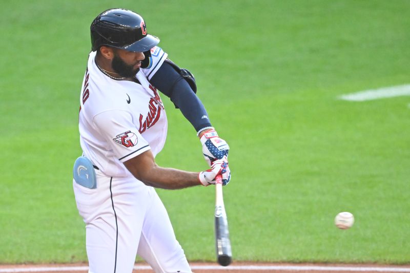 Jul 4, 2023; Cleveland, Ohio, USA; Cleveland Guardians shortstop Amed Rosario (1) hits a two-RBI double in the third inning against the Atlanta Braves at Progressive Field. Mandatory Credit: David Richard-USA TODAY Sports