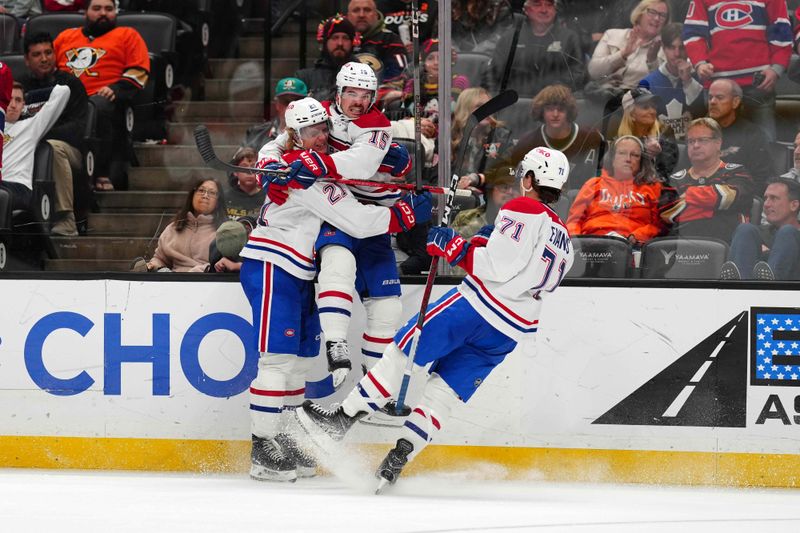 Nov 22, 2023; Anaheim, California, USA; Montreal Canadiens center Alex Newhook (15) celebrates with defenseman Kaiden Guhle (21) and center Jake Evans (71) after scoring a goal against the Anaheim Ducks in the third period at Honda Center. Mandatory Credit: Kirby Lee-USA TODAY Sports