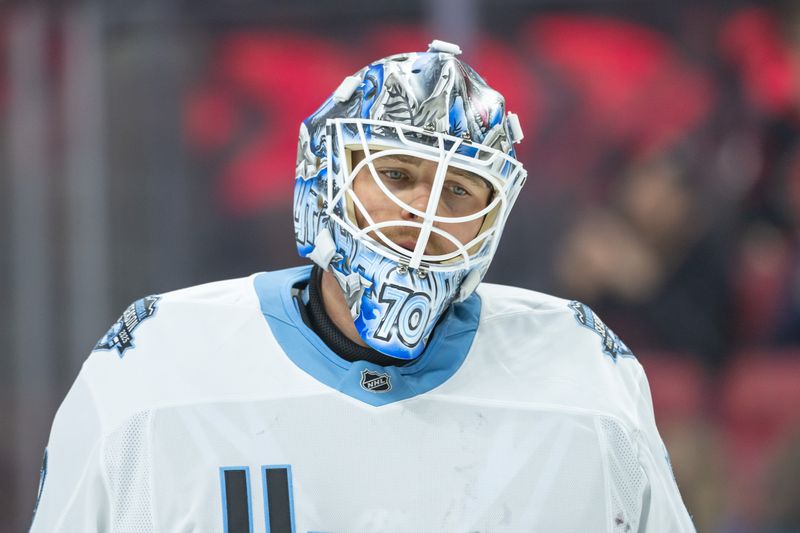 Jan 26, 2025; Ottawa, Ontario, CAN; Utah goalie Karel Vejmelka (70) skates in the first period against the Ottawa Senators at the Canadian Tire Centre. Mandatory Credit: Marc DesRosiers-Imagn Images