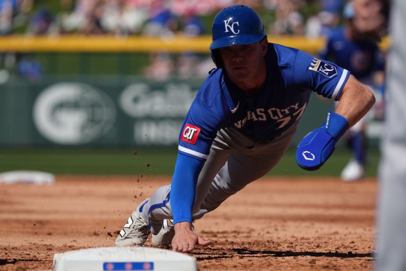 Mar 11, 2026; Mesa, Arizona, USA; Kansas City Royals second baseman Peyton Wilson (77) dives back to first against the Chicago Cubs in the third inning at Sloan Park. Mandatory Credit: Rick Scuteri-Imagn Images