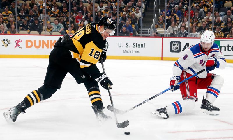 Oct 9, 2024; Pittsburgh, Pennsylvania, USA;  Pittsburgh Penguins right wing Jesse Puljujarvi (18) shoots the puck as New York Rangers defenseman Jacob Trouba (8) defends during the first period at PPG Paints Arena. Mandatory Credit: Charles LeClaire-Imagn Images