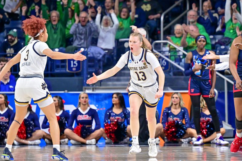 Mar 25, 2024; South Bend, Indiana, USA; Notre Dame Fighting Irish guard Anna Dewolfe (13) celebrates after a three point basket with guard Hannah Hidalgo (3)  in the first half against the Ole Miss Rebels in the NCAA Tournament second round game at the Purcell Pavilion. Mandatory Credit: Matt Cashore-USA TODAY Sports