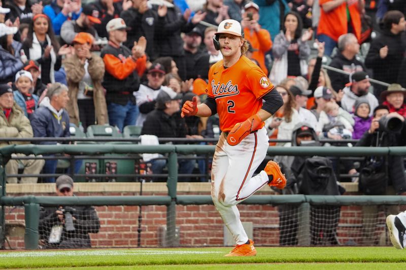 Apr 27, 2024; Baltimore, Maryland, USA; Baltimore Orioles shortstop Gunnar Henderson (2) scores a run on Baltimore Orioles right fielder Anthony Santander (not pictured) RBI double against the Oakland Athletics during the fourth inning at Oriole Park at Camden Yards. Mandatory Credit: Gregory Fisher-USA TODAY Sports